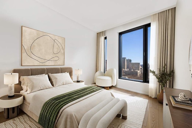 30 Front St Unit 28C, New York City, NY 11201 - bedroom with light wood-style flooring and vaulted ceiling