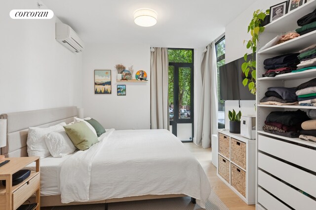 112 Fleet Pl Unit 2A, New York City, NY 11201 - bedroom featuring an AC wall unit and light wood finished floors