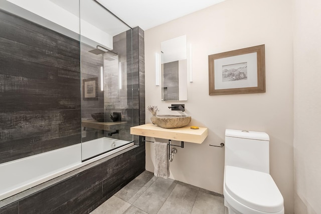 231 10th Ave Unit 5A, New York City, NY 10011 - bathroom featuring a sink, toilet, and tiled shower / bath