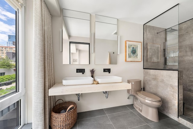 231 10th Ave Unit 5A, New York City, NY 10011 - full bath featuring walk in shower, toilet, a sink, and tile patterned flooring
