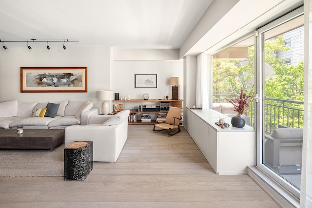 231 10th Ave Unit 5A, New York City, NY 10011 - living area with rail lighting and light wood-type flooring