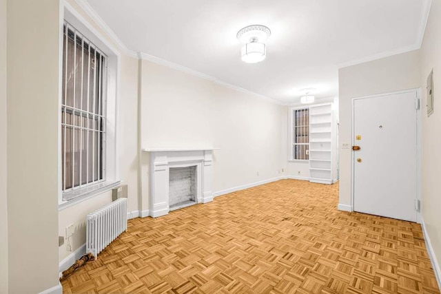 350 W 48th St Unit 1W, New York City, NY 10036 - unfurnished living room with radiator, a fireplace, baseboards, and crown molding