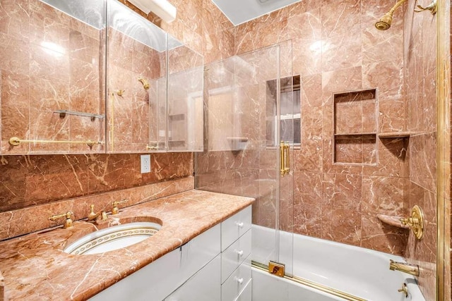 350 W 48th St Unit 1W, New York City, NY 10036 - bathroom with vanity, shower / bath combination with glass door, and tile walls
