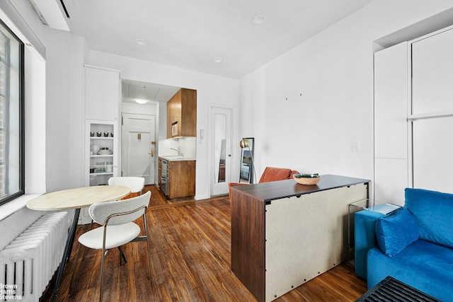 25 Tudor City Pl Unit 2101, New York City, NY 10017 - office area featuring radiator and dark wood-style flooring