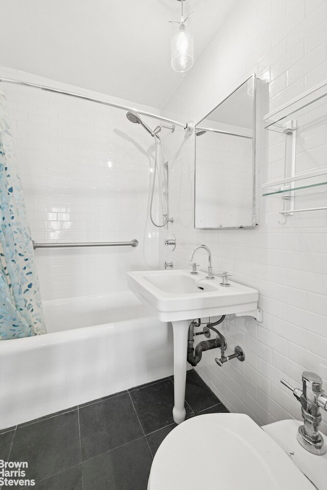 25 Tudor City Pl Unit 2101, New York City, NY 10017 - bathroom featuring shower / bath combination with curtain, toilet, tile patterned flooring, and tile walls