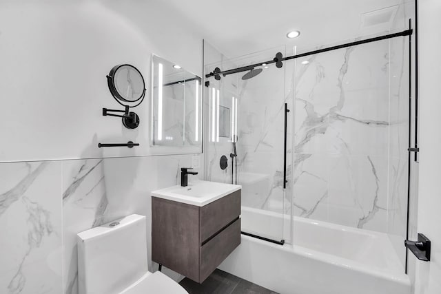 199 Bowery Unit 2D, New York City, NY 10003 - bathroom featuring vanity, combined bath / shower with glass door, toilet, and recessed lighting