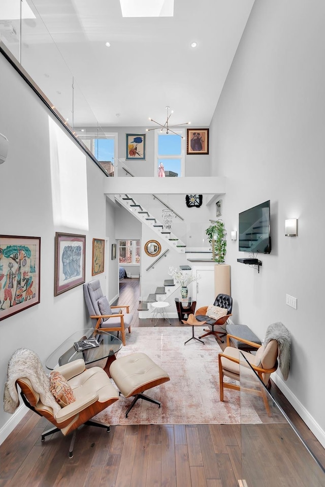 459 Vanderbilt Ave, New York City, NY 11238 - living room featuring a high ceiling, stairs, wood-type flooring, and a skylight