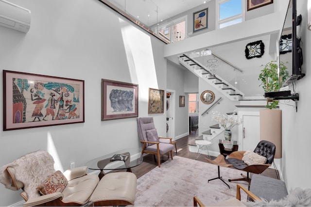 459 Vanderbilt Ave, New York City, NY 11238 - sitting room with a high ceiling, stairway, a wall mounted AC, and wood finished floors
