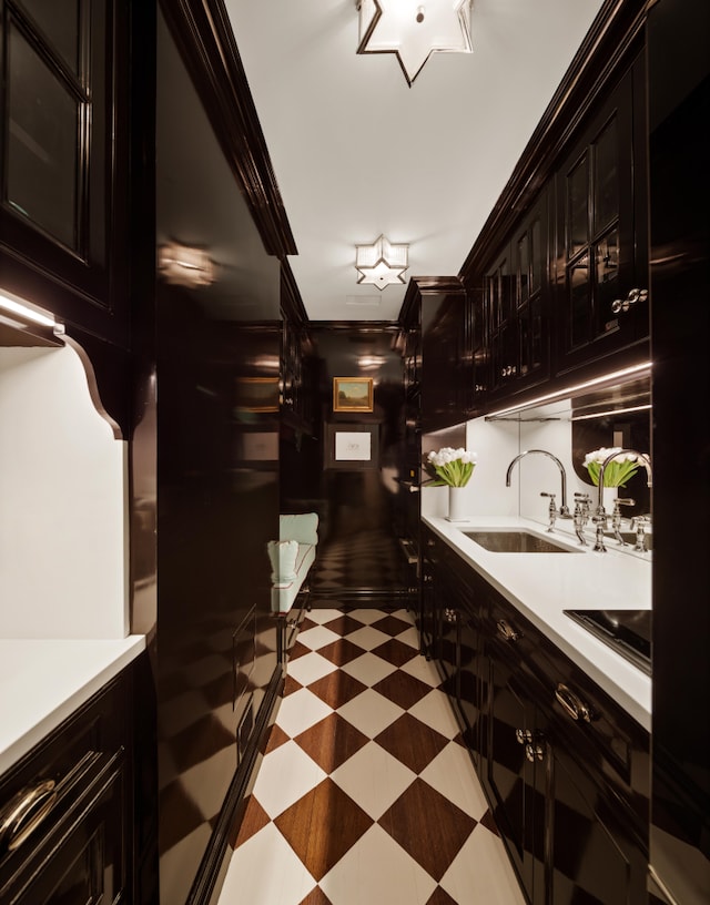 35 E 76th St Unit 415, New York City, NY 10021 - bar area featuring light flooring, black electric stovetop, a sink, and ornamental molding