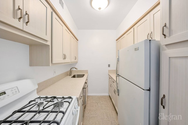 165 E 32nd St Unit 15C, New York City, NY 10016 - kitchen with white appliances, a sink, light countertops, and baseboards