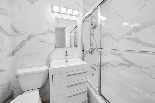 305 E 40th St Unit 10W, New York City, NY 10016 - bathroom with tile walls, combined bath / shower with glass door, vanity, and toilet
