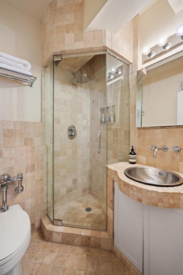 45 W 54th St Unit 11/12A, New York City, NY 10019 - full bathroom featuring tile walls, a stall shower, and vanity
