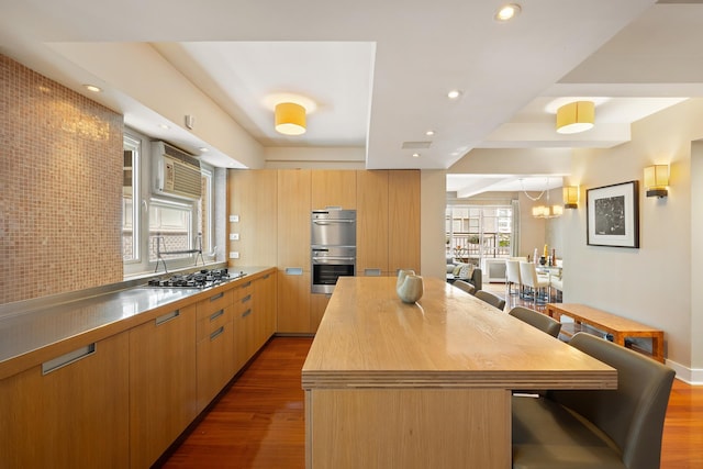 45 W 54th St Unit 11/12A, New York City, NY 10019 - kitchen featuring stainless steel appliances, dark wood-type flooring, a center island, recessed lighting, and modern cabinets