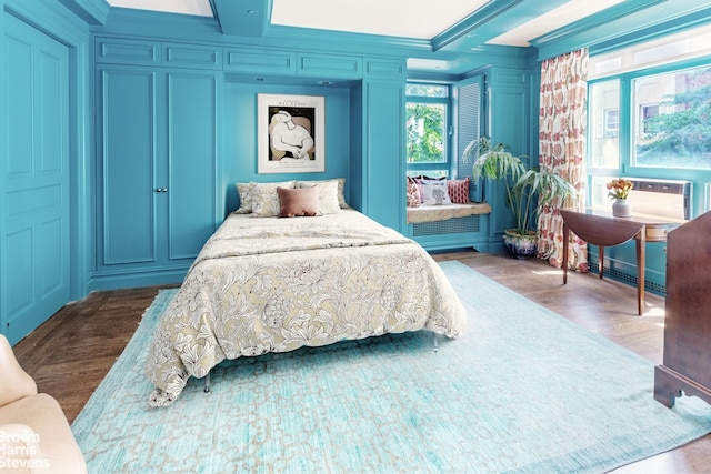 2 Beekman Pl Unit 5Ag, New York City, NY 10022 - bedroom with wood finished floors, a decorative wall, and crown molding