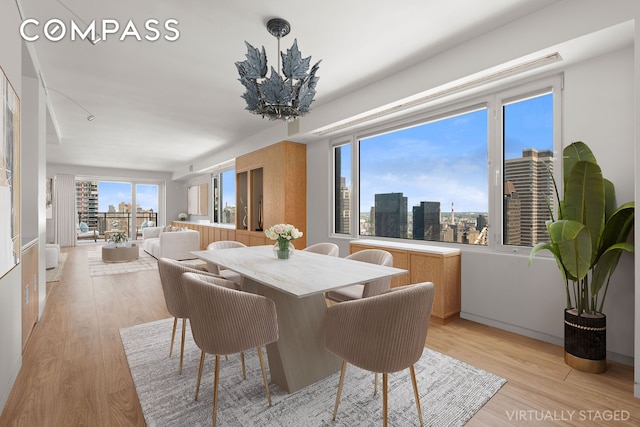 303 E 57th St Unit 33Ef, New York City, NY 10022 - dining space with light wood finished floors and a city view