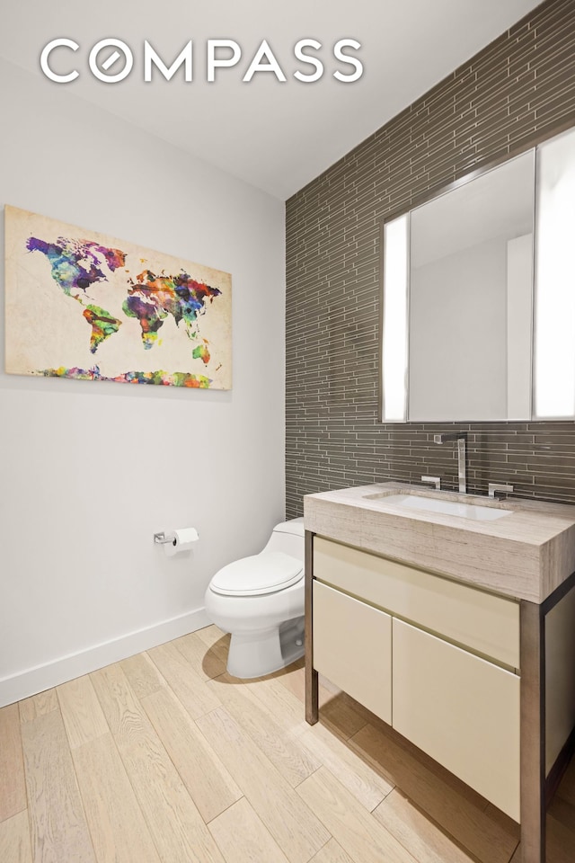 75 Wall St Unit 25K, New York City, NY 10005 - bathroom with vanity, wood finished floors, and backsplash