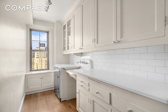 45 Christopher St Unit 12/14F, New York City, NY 10014 - washroom featuring light wood finished floors, a sink, and baseboards