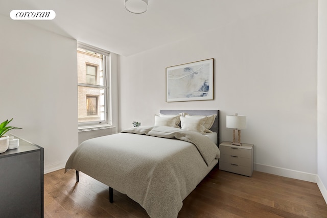 25 Broad St Unit 6M, New York City, NY 10004 - bedroom with baseboards and wood finished floors