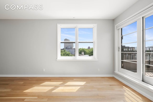 195 Hawthorne St Unit 5E, New York City, NY 11225 - spare room with light wood finished floors, baseboards, and healthy amount of natural light