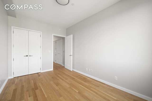 195 Hawthorne St Unit 5E, New York City, NY 11225 - unfurnished bedroom featuring baseboards, light wood-style floors, and a closet