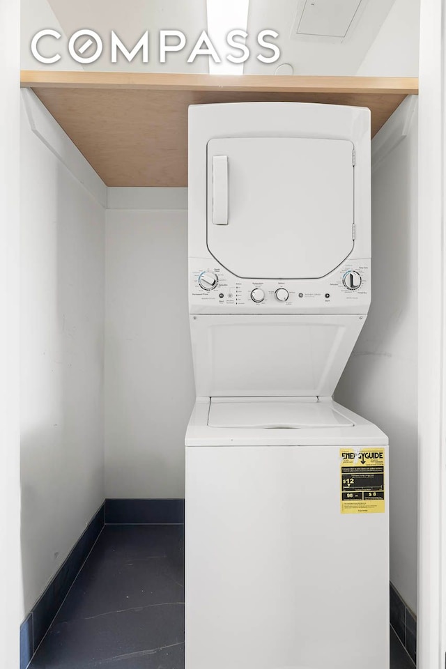 195 Hawthorne St Unit 5E, New York City, NY 11225 - laundry area featuring stacked washing machine and dryer and baseboards