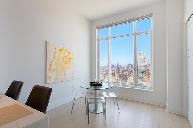 30 Park Pl Unit 64B, New York City, NY 10007 - dining space with healthy amount of natural light, wood finished floors, and a city view