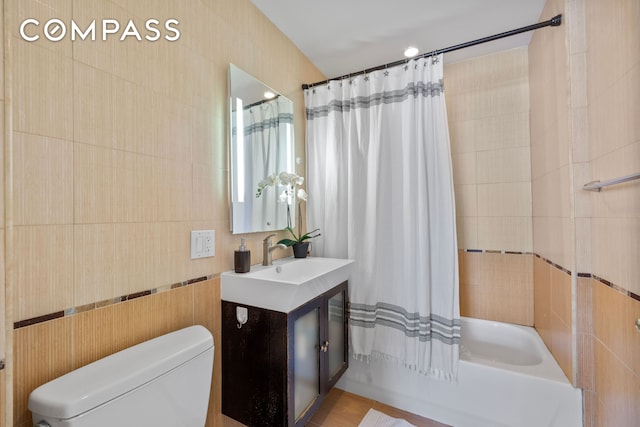3001 Fort Hamilton Pkwy Unit 3B, New York City, NY 11218 - bathroom featuring vanity, shower / bathtub combination with curtain, toilet, and tile walls