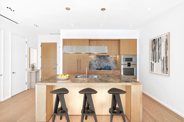 30 Front St Unit 28C, New York City, NY 11201 - kitchen featuring double oven, a breakfast bar, tasteful backsplash, under cabinet range hood, and light wood finished floors