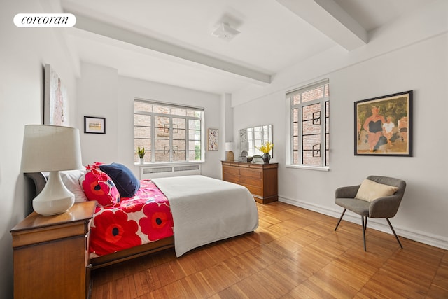 118 8th Ave Unit 2D, New York City, NY 11215 - bedroom featuring beam ceiling, wood finished floors, and baseboards