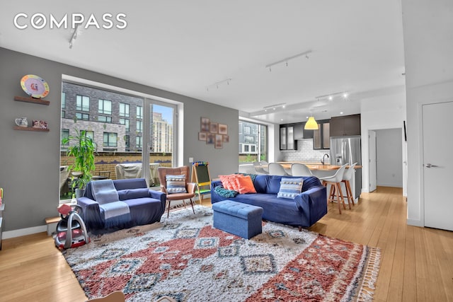 40 W 116th St Unit A907, New York City, NY 10026 - living room with track lighting, light wood finished floors, and baseboards