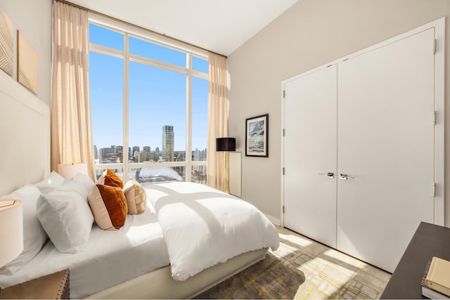 400 Park Ave S Unit 26C, New York City, NY 10016 - bedroom featuring expansive windows, a skyline view, and a closet