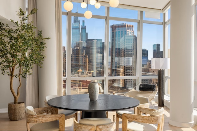 400 Park Ave S Unit 26C, New York City, NY 10016 - dining space featuring expansive windows, a view of skyline, and wood finished floors