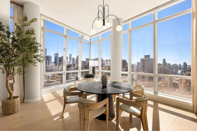 400 Park Ave S Unit 26C, New York City, NY 10016 - sunroom / solarium featuring a skyline view, a wall of windows, wood finished floors, and a chandelier