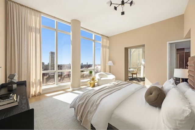 400 Park Ave S Unit 26C, New York City, NY 10016 - bedroom featuring a skyline view, expansive windows, and wood finished floors