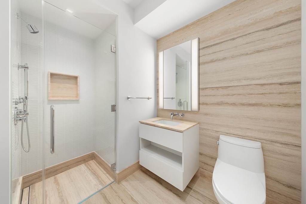 1 Wall St Unit 932, New York City, NY 10005 - bathroom featuring vanity, a shower stall, and wood finished floors