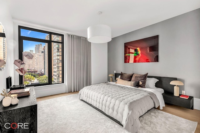 310 E 86th St Unit 14B, New York City, NY 10028 - bedroom featuring wood finished floors and a view of city