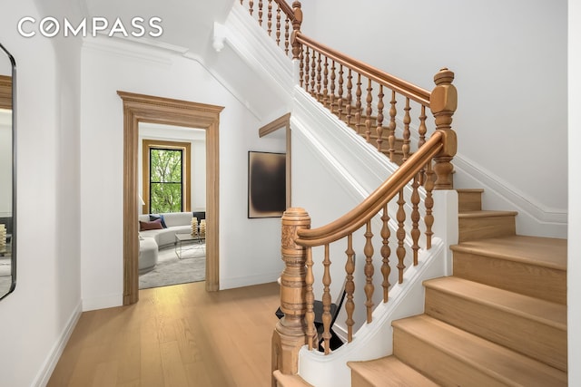 53 W 85th St, New York City, NY 10024 - staircase with wood finished floors, baseboards, and crown molding