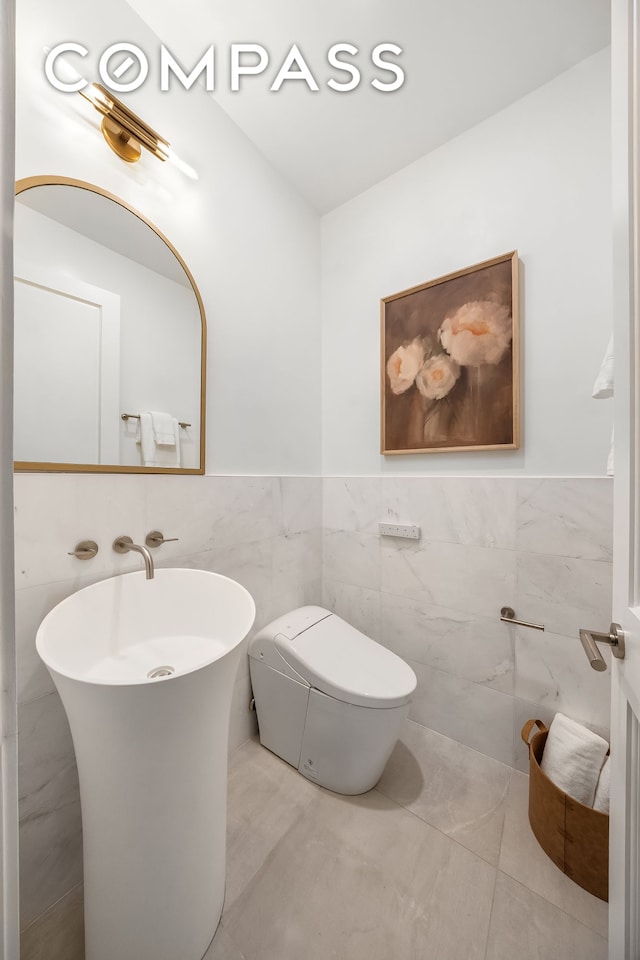 53 W 85th St, New York City, NY 10024 - half bath featuring tile walls, toilet, and a wainscoted wall