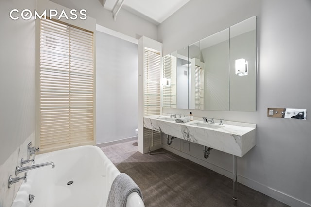 32 W 20th St Unit 5, New York City, NY 10011 - full bath with a freestanding bath, toilet, and baseboards