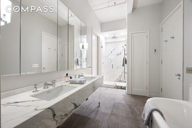 32 W 20th St Unit 5, New York City, NY 10011 - full bath featuring a marble finish shower, double vanity, and a bathtub