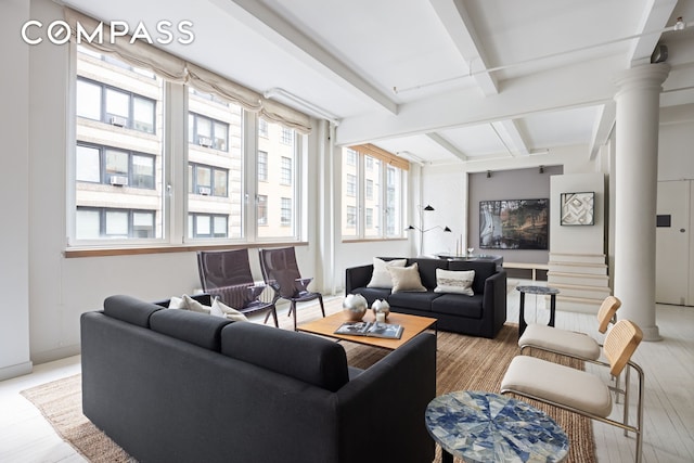 32 W 20th St Unit 5, New York City, NY 10011 - living room featuring beam ceiling, plenty of natural light, light wood finished floors, and decorative columns