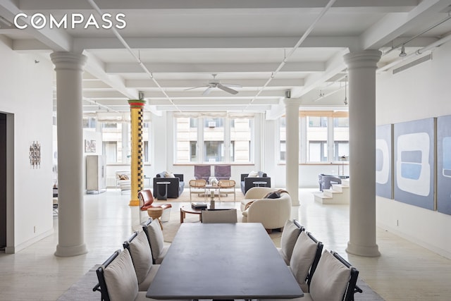 32 W 20th St Unit 5, New York City, NY 10011 - dining space featuring ornate columns, a ceiling fan, beam ceiling, wood finished floors, and baseboards
