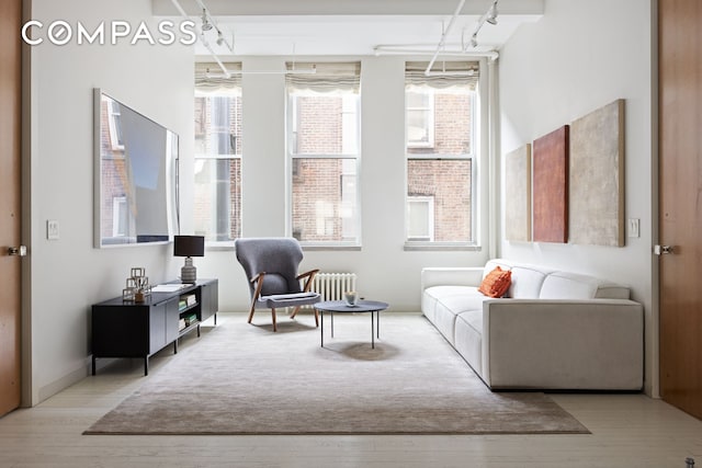 32 W 20th St Unit 5, New York City, NY 10011 - sitting room with healthy amount of natural light, wood finished floors, and radiator heating unit
