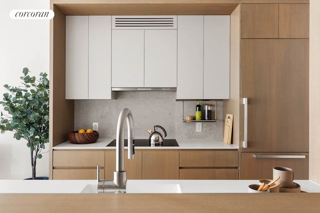 428 W 19th St Unit 2C, New York City, NY 10011 - kitchen with light countertops, backsplash, modern cabinets, and white cabinets