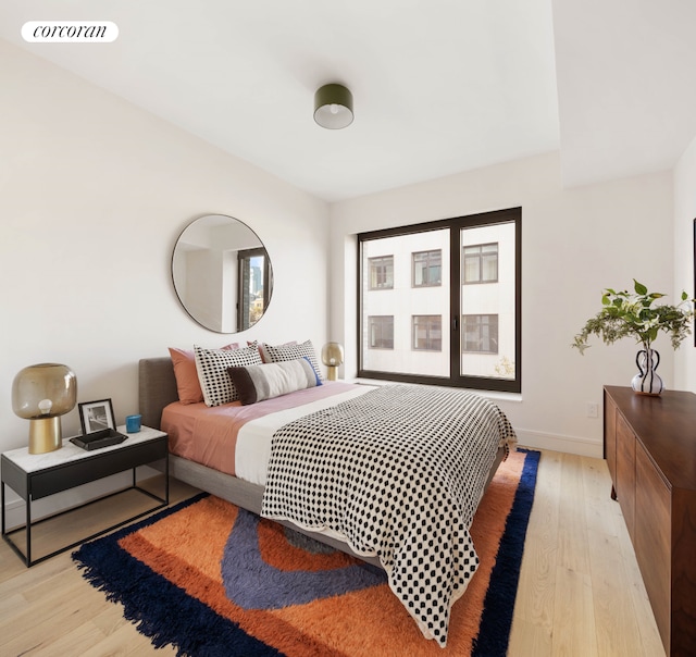 428 W 19th St Unit 2C, New York City, NY 10011 - bedroom with light wood-style floors and baseboards