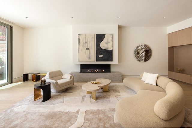 85 Worth St Ph, Ph, New York City, NY 10013 - living room featuring wood finished floors and a lit fireplace