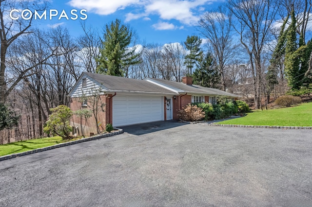 420 Ocean Ter, New York City, NY 10301 - ranch-style house with a garage, brick siding, a chimney, driveway, and a front yard