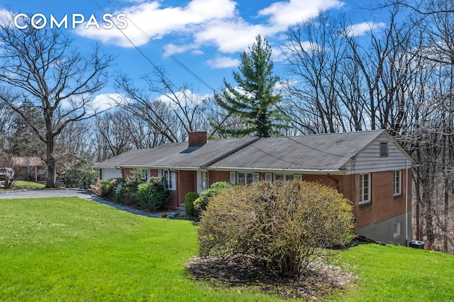 420 Ocean Ter, New York City, NY 10301 - view of front facade featuring brick siding, a front yard, asphalt driveway, and a chimney