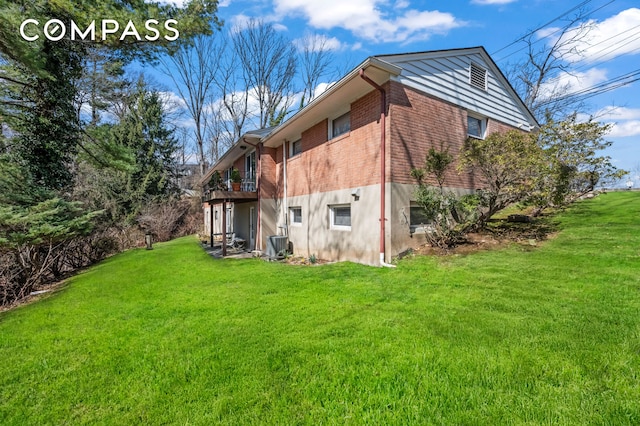 420 Ocean Ter, New York City, NY 10301 - rear view of property featuring a lawn, brick siding, cooling unit, and a deck