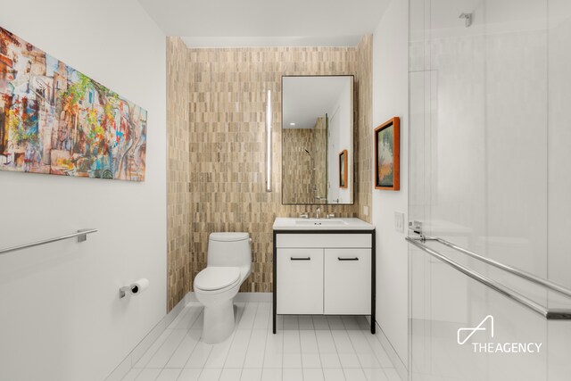 70 Charlton St Unit 4F, New York City, NY 10014 - full bathroom with vanity, tile walls, and tile patterned flooring